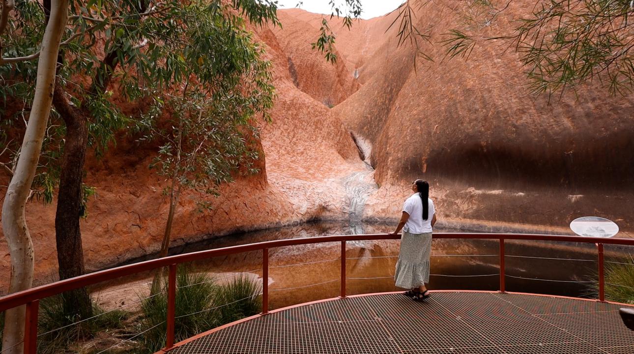 Lady standing in front of Uluru